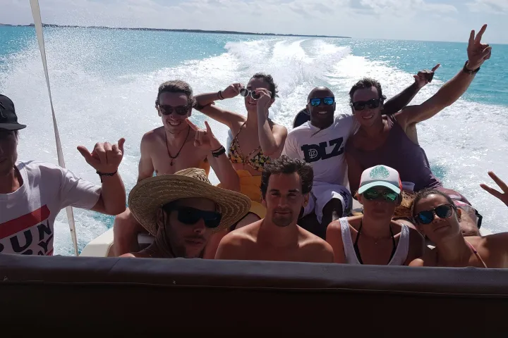 a group of people standing next to a body of water