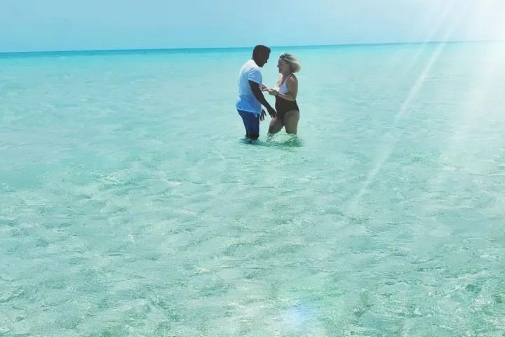 a man that is standing in the ocean