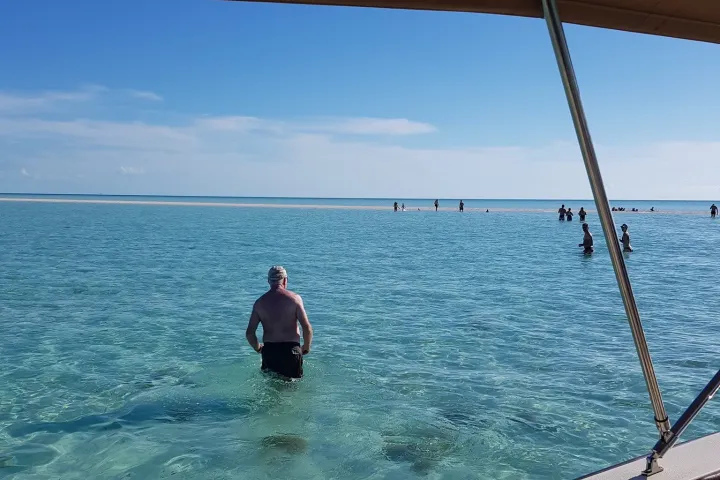 a person standing next to a body of water