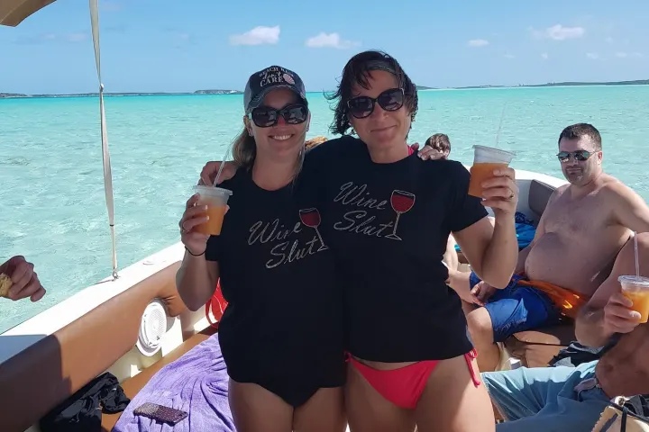 a group of people standing next to a body of water
